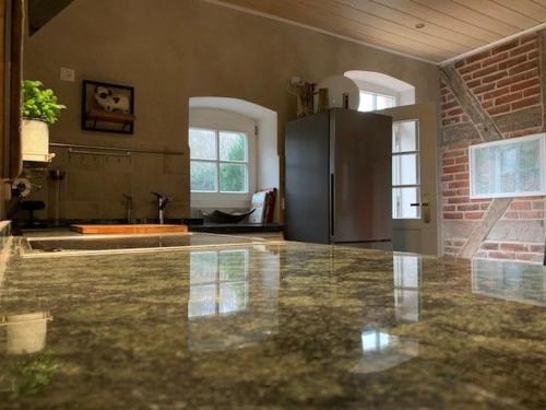 a kitchen with a counter top and a refrigerator at Waldhaus Jellen in Dobbertin