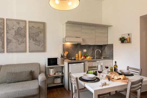 a kitchen and living room with a table and a couch at Fornaci Vatican Flat in Rome