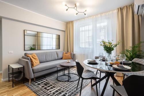 a living room with a couch and a table at Sunny 2BR Flat - Top Location - Stunning Views in Bucharest