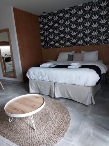 a bedroom with two beds and a table and a bed at Chapter 02 Gallery Suites - ex GD Gallery Suites in Heraklio Town