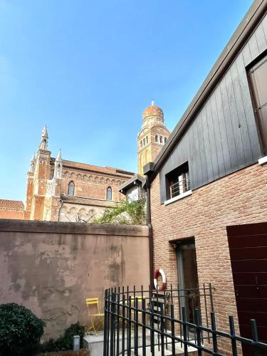 a large brick building with a clock tower in the background at Ca' Tintoretto in Venice