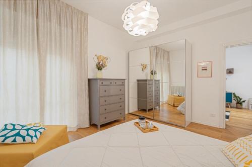 a bedroom with a bed and a dresser and a mirror at Casa Gioggiò in Terni