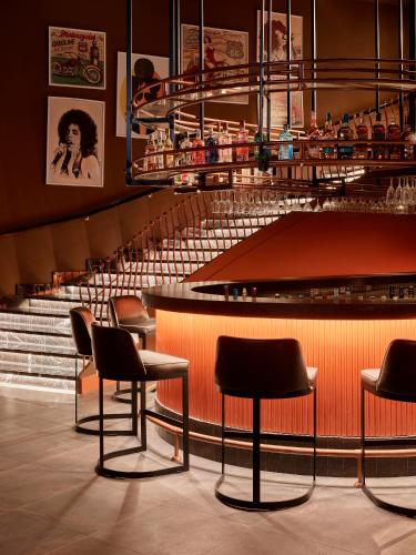 a bar with chairs and stairs in a restaurant at Lara Barut Collection-Ultra All Inclusive in Lara