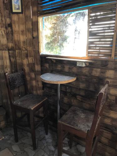 a table and two chairs in a room with a window at Деревенский домик,Eco Chakvi in Chakvi