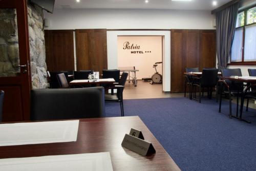 a dining room with tables and chairs and a chalkboard at Hotel Patria Zakopane Centrum in Zakopane