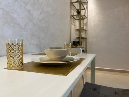 a table with a bowl and a plate on it at Cosy & Quiet Expat Studio in Kenitra