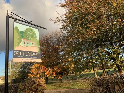 a sign for a house in a park with trees at Southernwood - Garden Lodge 3 in Didcot