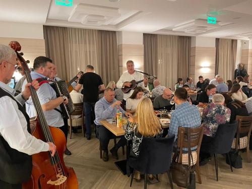 a group of people sitting at tables in a room with instruments at Konak Stella in Belgrade