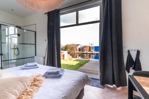 - une chambre avec un lit et une grande fenêtre dans l'établissement Proosdij B055A, à Vinkeveen