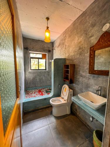 a bathroom with a toilet and a sink at Nalanda Retreat Goa By Mandrem Beach in Mandrem