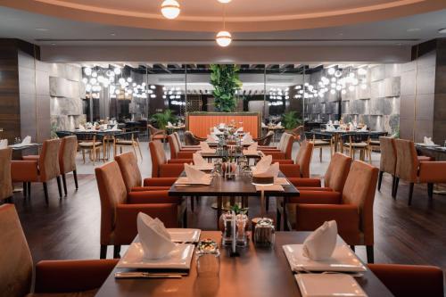 a dining room with tables and chairs in a restaurant at Lara Barut Collection-Ultra All Inclusive in Lara