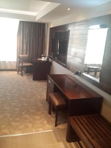 a hotel room with a desk and a television at Boma Inn Eldoret in Eldoret