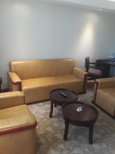 a living room with a couch and two tables at Boma Inn Eldoret in Eldoret