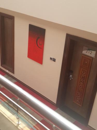 a hallway with a door and a painting on the wall at Boma Inn Eldoret in Eldoret