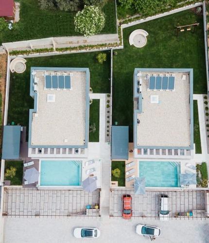 an overhead view of a building with two swimming pools at Villa Besca with heated infinity pool in Baška