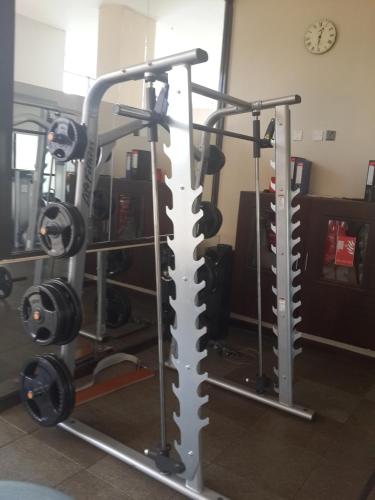 a gym with two treadmills and weights at Boma Inn Eldoret in Eldoret