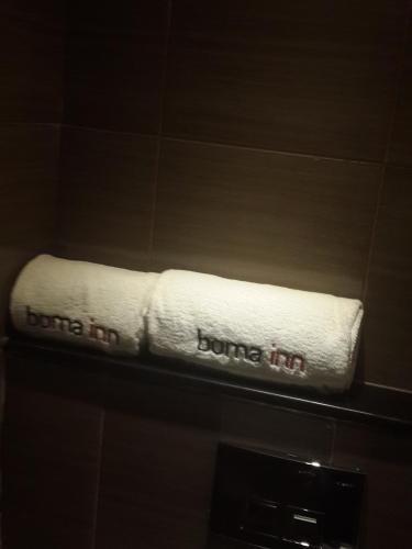 a white towel with the words bounce in on a shelf at Boma Inn Eldoret in Eldoret