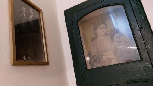 a green cabinet with a picture on a wall at Antica Via delle Aie in Ruffano