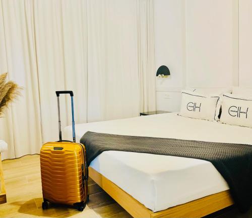 a hotel room with a bed and a suitcase at CIH Apartments in Puerto del Carmen