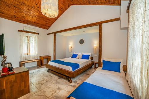 a bedroom with two beds and a large window at Dalya Life in Göcek