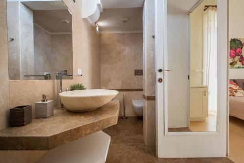 a bathroom with a sink and a toilet at Tenuta Rocci Cerasoli in Parabita