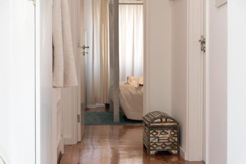a hallway with a room with a bed and a wooden floor at Flat With a Garden in Belem in Lisbon