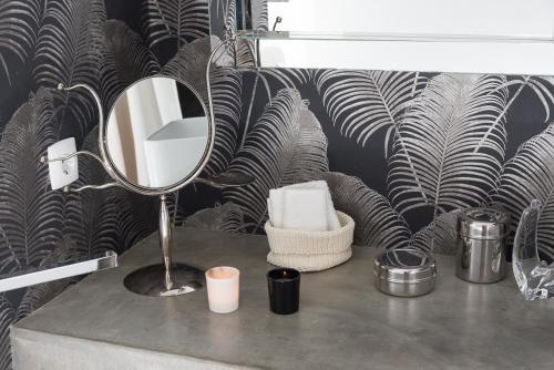 a bathroom with a mirror on a counter with a sink at Flat With a Garden in Belem in Lisbon