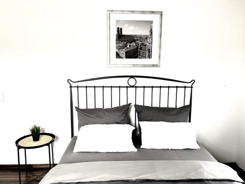ein schwarz-weißes Schlafzimmer mit einem Bett und einem Tisch in der Unterkunft Amazing & design 2-room apartment near Cologne in Trompete