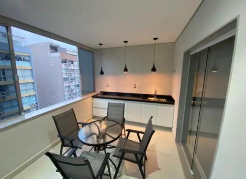 Zimmer mit einem Tisch und Stühlen sowie einer Küche in der Unterkunft Apartamento moderno em Copacabana in Rio de Janeiro
