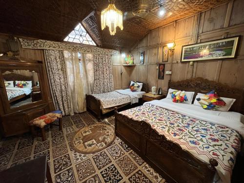 a bedroom with two beds and a chandelier at Young Shahzada Group of Houseboats in Srinagar