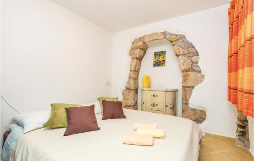 a bedroom with a white bed with a stone archway at Amazing Home In Moscenicka Draga With 4 Bedrooms And Wifi in Mošćenička Draga