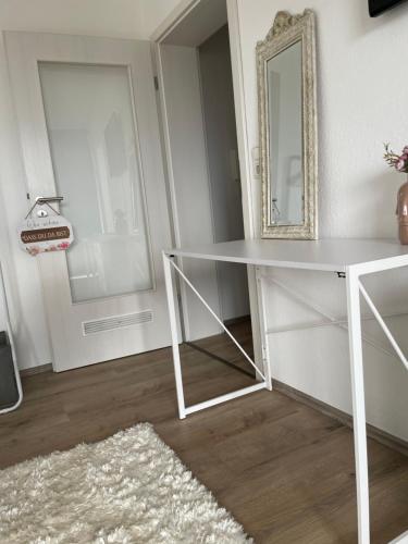 a white desk in a room with a mirror at Apartment mit schönem Ausblick in Lüdenscheid