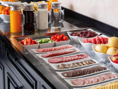 a buffet with different types of fruits and vegetables at Mercure Tashkent in Tashkent
