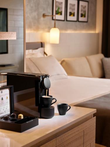 a coffee machine on a table in a living room at Lara Barut Collection-Ultra All Inclusive in Lara