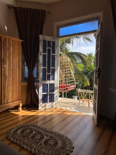 an open door to a room with a view of a playground at Habibi Hostel & Restaurant in Unawatuna