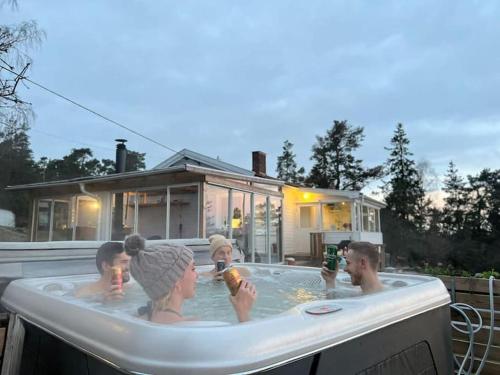 a group of people in a hot tub at Archipelago villa, cabin & sauna jacuzzi with sea view, 30 minutes from Stockholm in Tyresö