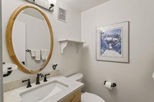 a bathroom with a sink and a mirror at 60 Fall Lane Sonnenblick #3 Townhouse in Snowmass Village