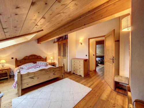 een slaapkamer met een bed en een houten plafond bij Bells Lodge in Chamonix-Mont-Blanc