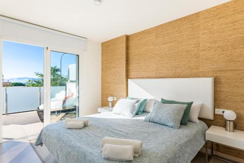 a bedroom with a large bed and a large window at 149 VILLA OASIS Buddha Garden by Sunkeyrents in Adeje
