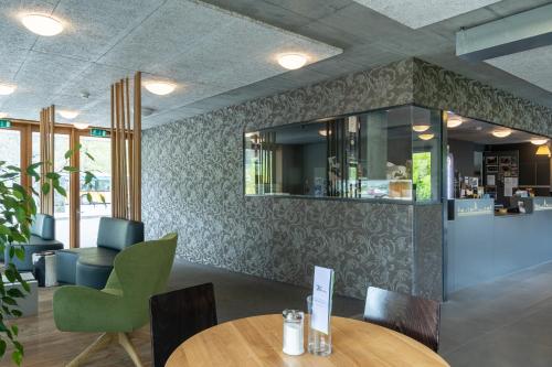 a restaurant with tables and chairs and a bar at Chalet Hostel @ Backpackers Villa Interlaken in Interlaken