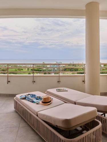 two beds on a balcony with a view of the ocean at Lara Barut Collection-Ultra All Inclusive in Lara