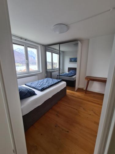 a bedroom with two beds and two windows at The View of Austria! in Gmunden