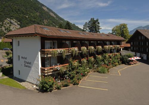 a large building with a clock on the front of it at Hotel Chalet Swiss in Interlaken