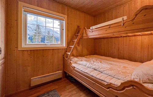 a bunk bed in a wooden room with a window at 4 Bedroom Stunning Home In Hemsedal in Hemsedal