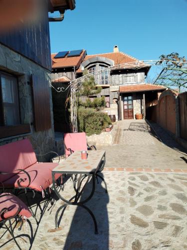 a table and chairs sitting on a patio at Seosko turističko domacinstvo Imunsan in Niš