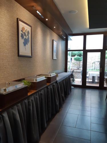 a waiting room with a row of chairs and sinks at LONDON Boutique hotel & Restaurant in Trnava