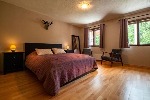 a bedroom with a large bed and a wooden floor at Rudnica House in Bohinj