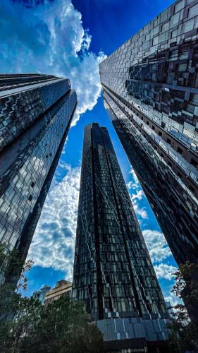 two tall buildings are looking up at the sky at AXQUISITE SUITES at KLCC in Kuala Lumpur
