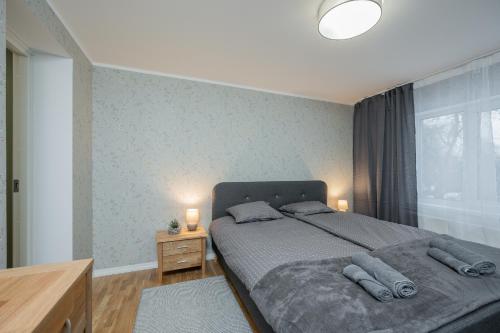 a bedroom with a bed with two pillows on it at Loode lux with sauna in Tartu