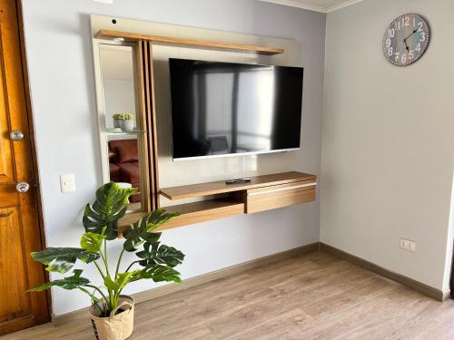 Una televisión o centro de entretenimiento en Spazios Apart Hotel Reñaca
